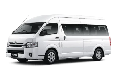 Toyota Hiace Commuter putih tampak serong depan dan samping untuk layanan sewa Hiace Tangerang dengan driver profesional