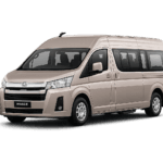 Toyota Hiace Premio coklat muda metallic tampak serong depan dan samping untuk layanan sewa Hiace Tangerang dengan driver profesional